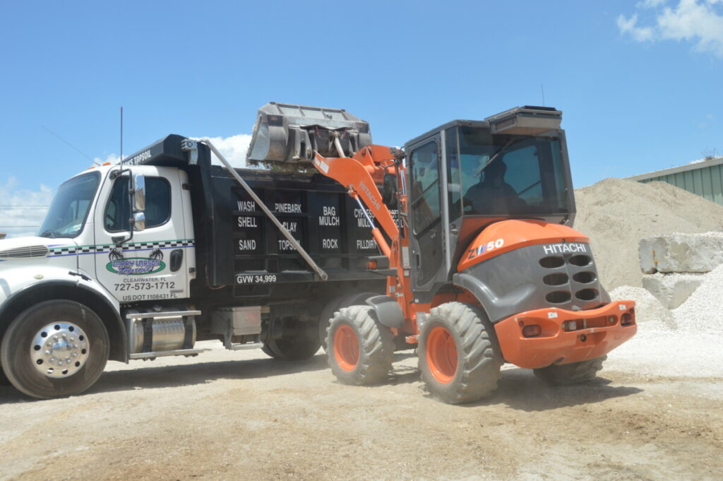 Larry Larson prefers Hitachi compact loaders over skid steers for loading the tallest haul trucks