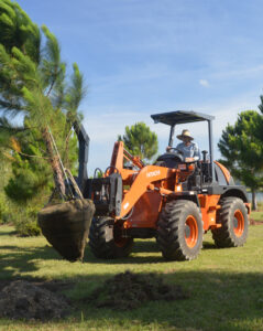 Troy Springer with Hitachi wheel loader with a tree boom